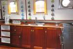 Wooden galley with a cooker and worktop on the tjalk Aagtje