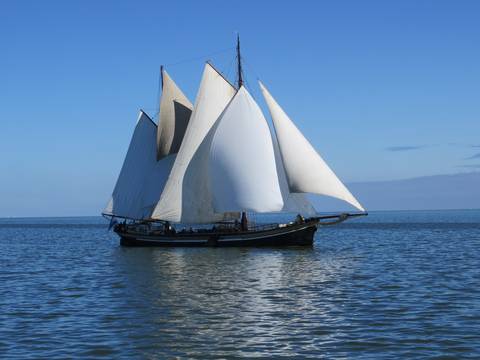 Two-masted clipper Avontuur under full sail on open water