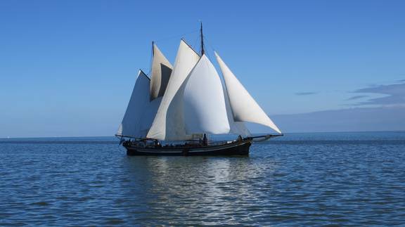 Two-masted clipper Avontuur under full sail on open water