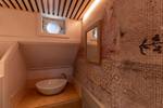 Washbasin beneath a porthole in a cabin of the Avontuur