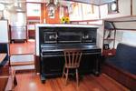 Piano in the saloon of the tjalk Aagtje