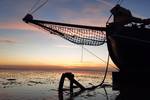 Bow of the tjalk Aagtje at sunset on the Wadden Sea