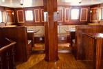 Wooden benches and tables in the saloon of the Abel Tasman