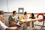 Guests at an outdoor table aboard the Abel Tasman