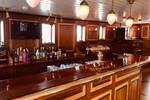 Wooden bar with glasses and bottles aboard the Abel Tasman