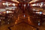 Saloon of the Abel Tasman with wooden tables and ambient lighting