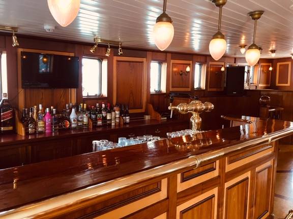 Wooden bar with glasses and bottles aboard the Abel Tasman