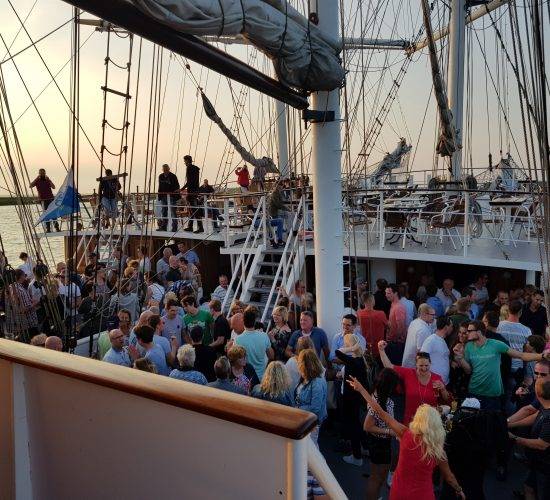 Guests at a party on the deck of the Abel Tasman