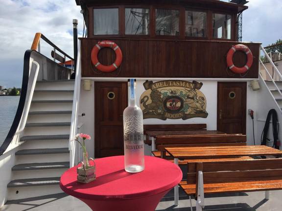Middle deck of the Abel Tasman with a standing table and stairs