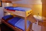 Wooden bunk bed and washbasin in a cabin of the Albatros