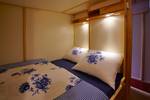 Enclosed double berth with blue-and-white bedding on the Albatros