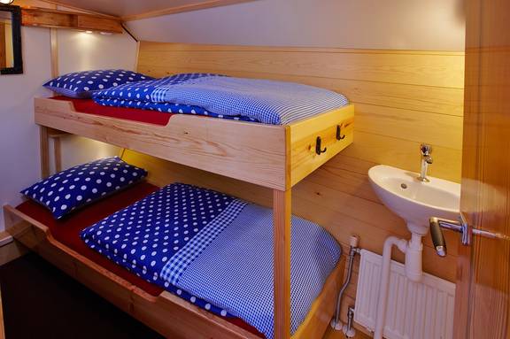 Wooden bunk bed and washbasin in a cabin of the Albatros