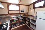 Galley of the Allure with a cooker, refrigerator and stainless-steel worktop