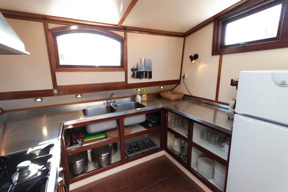 Galley of the Allure with a cooker, refrigerator and stainless-steel worktop