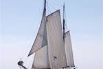 Clipper Allure with sails hoisted on open water