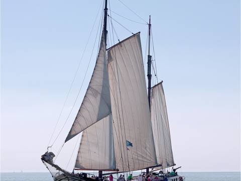 Clipper Allure with sails hoisted on open water