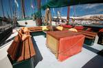 Wooden table and benches in the deck seating area of the Allure