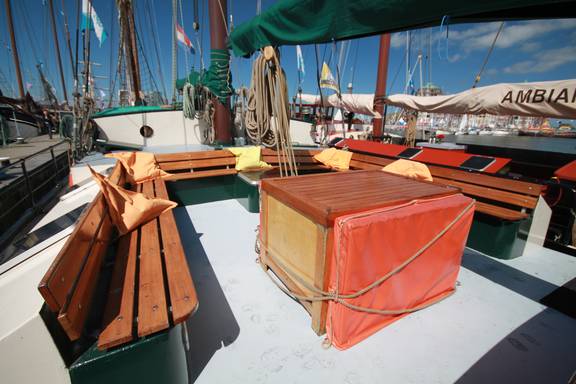 Wooden table and benches in the deck seating area of the Allure