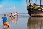 School pupils posing beside the Ambiance on the exposed tidal flats