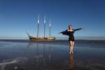 Guest on the tidal flats with the beached Ambiance in the background