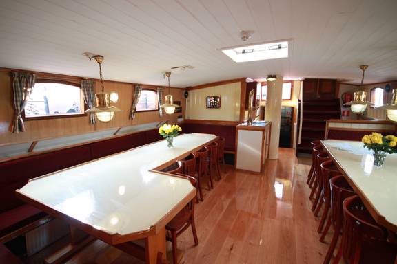 Saloon of the Ambiance with long dining tables and red benches