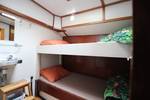 Twin-berth cabin with a bunk bed and washbasin on the Anna Trijntje