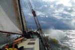 Anna Trijntje sailing through the waves beneath a cloudy sky