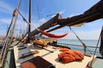 Sunny deck of the Anna Trijntje with a hammock and cushions