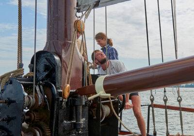 Hoisting the sails on the deck of the clipper Anna