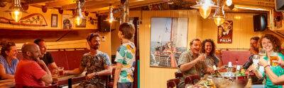 Guests in the saloon with a bar aboard the Anna