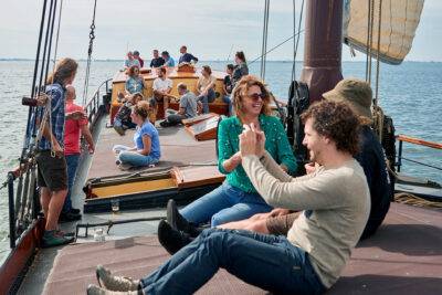 Guests sitting together on the deck of the clipper Anna