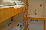 Wooden bunk bed and washbasin in a cabin of the Avanti