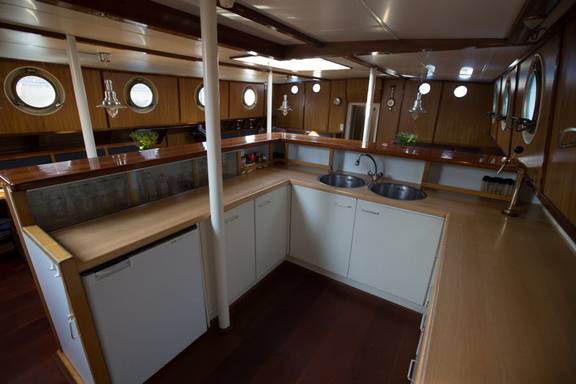 Galley with white kitchen units and wooden trim on the Avanti
