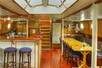 Saloon with a bar, dining tables and skylights on the Avanti