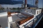 Deck seating area with wooden benches on the Avanti