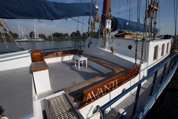 Deck seating area with wooden benches on the Avanti