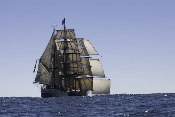 Barque Europa under full sail at sea, viewed from behind