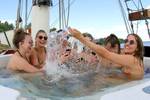 Guests splashing water in the hot tub on the Summertime