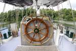 Wooden wheel on the aft deck of the Summertime