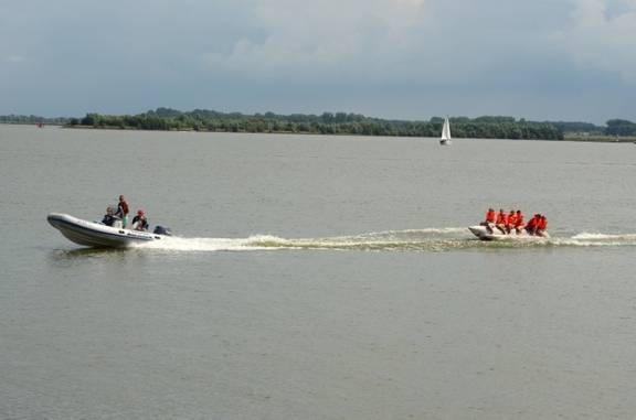 RIB of the Summertime towing guests on an inflatable ring across the water