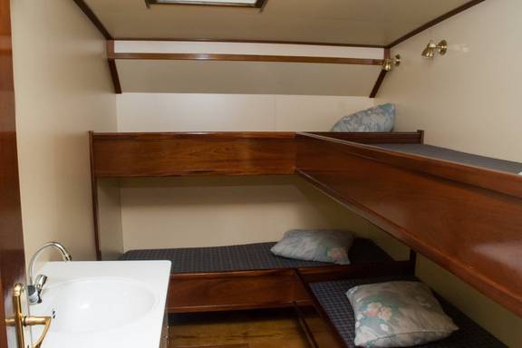 Four-berth cabin with bunk beds and a washbasin on the Summertime
