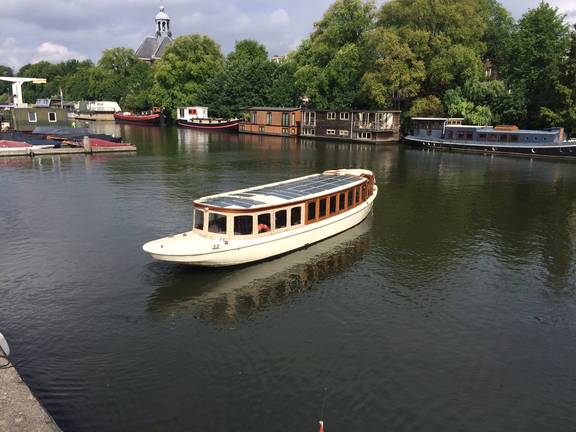 Saloon boat Belle van Zuylen cruising along an Amsterdam canal