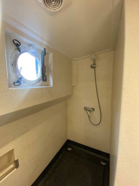Shower with a porthole aboard the Boekanier