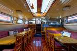 Overview of the saloon of the Boekanier with a wooden floor and skylights