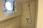 Shower with a porthole aboard the Boekanier