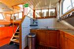 Galley with wooden cabinets beside the stairs on the Boekanier