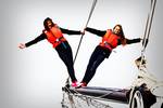 Two pupils wearing life jackets balancing beside the rigging of the Broedertrouw