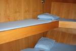 Cabin with wooden bunk beds on the Broedertrouw