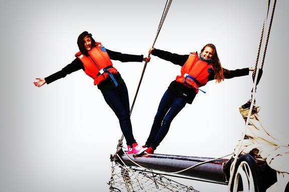 Two pupils wearing life jackets balancing beside the rigging of the Broedertrouw