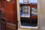 View through a ship doorway into a four-berth cabin of the Chateauroux